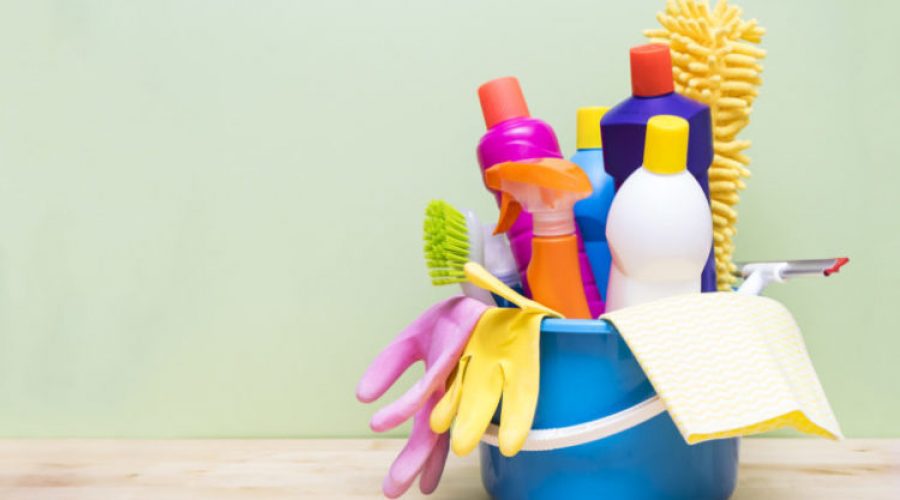 House cleaning product on wood table with green background